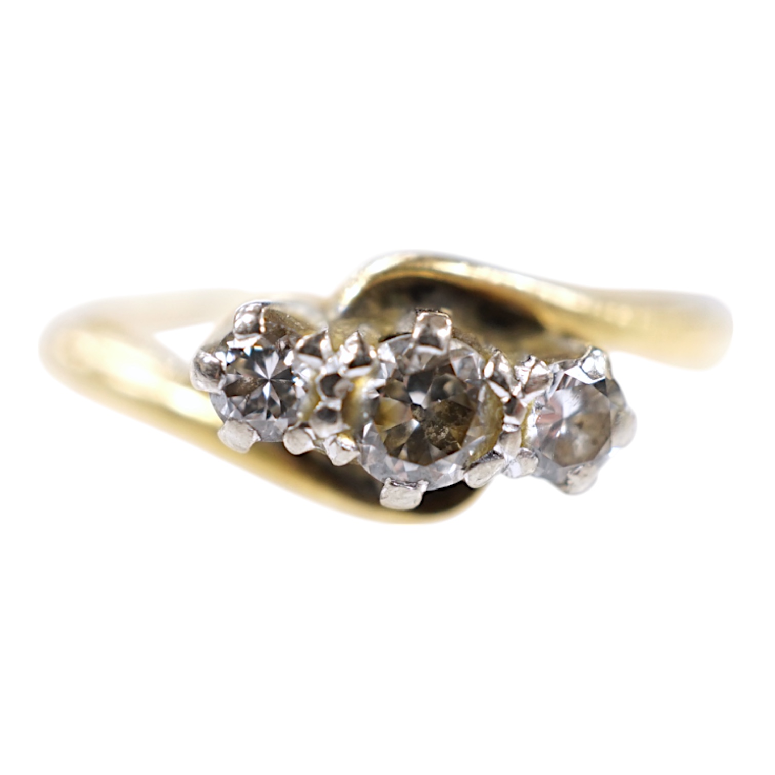 A modern `18ct gold and three stone diamond set crossover ring, size O, gross weight 3.4 grams. Condition - fair